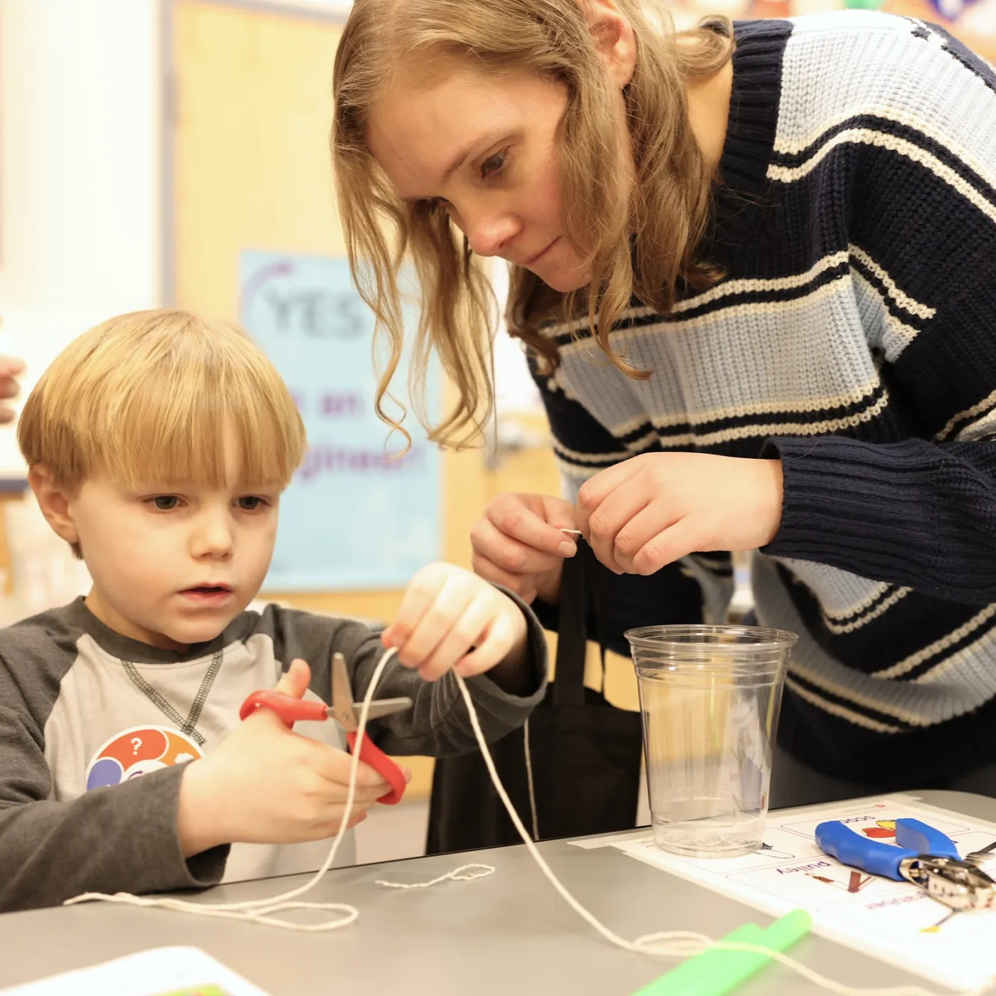 child and parent work with materials together